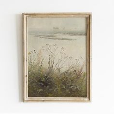 a painting hanging on the wall next to a white wall with plants and flowers in it