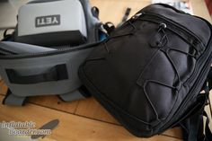 two backpacks sitting on top of a wooden table