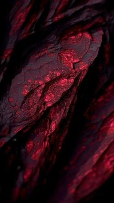 an abstract red and black background with some sort of rock formation in the foreground