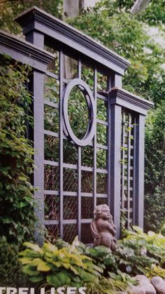 there is a garden gate in the middle of some bushes