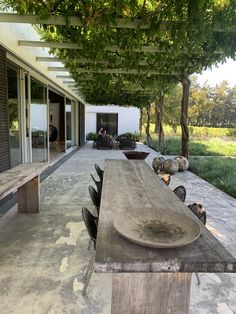 a long wooden table sitting on top of a patio