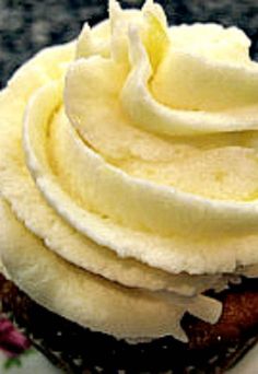 a cupcake with white frosting and bananas on top