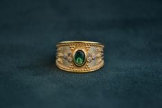 A mid-century inspired ring (Byzantine/Etruscan), that is made with solid Sterling Silver (925 silver). The outer layer is 22K Gold-plated, and in the middle there is an oval cz Emerald. Around it, there are 6 small white CZs. Byzantine Ring, Byzantine Gold, Byzantine Rings, Byzantine Jewelry, Greek Ring, Medieval Rings, Gold Amethyst Ring, Multi Gemstone Ring, Handmade Sterling Silver Rings