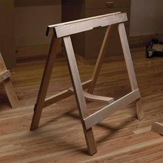 a wooden stool sitting on top of a hard wood floor next to a desk and chair