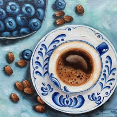 a painting of a cup of coffee with blueberries and almonds next to it