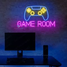 a neon sign that says game room with a video game controller in front of it