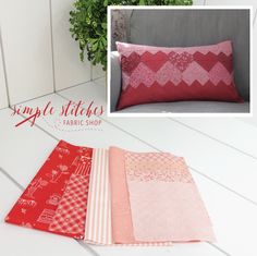 some red and pink pillows on a white table next to a potted green plant