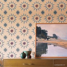 two vases sit on a dresser next to a painting