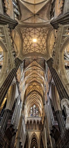 the interior of a cathedral with high vaulted ceilings and stone pillars, looking up at the ceiling