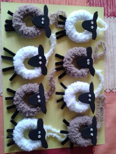 sheep and lambs made out of felt on yellow paper