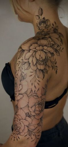 a woman's arm with flowers on it, and the back of her body