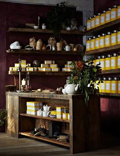 the shelves are filled with honey jars and flowers