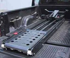 the back end of a pickup truck with an extended bed tray and tool box on it