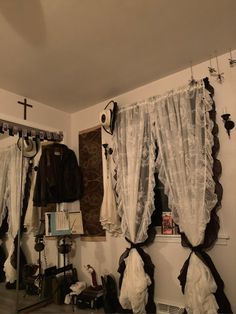 a room with several pieces of clothing hanging on the wall and two mirrors in front of them