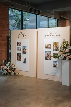 flowers and pictures are on display in front of large windows at an event or conference