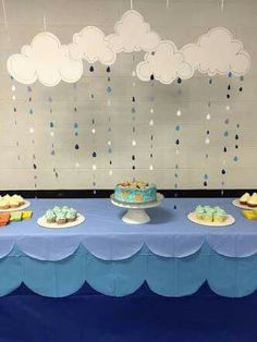 a blue table topped with cakes and cupcakes