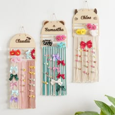 three wall hangings decorated with bows and hair clips