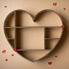 a heart shaped cardboard box sitting on top of a table