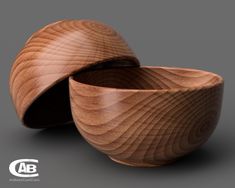 two wooden bowls sitting next to each other