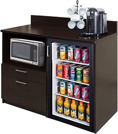 an open refrigerator with drinks in it and a microwave on the counter next to it