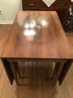 a wooden table sitting on top of a hard wood floor