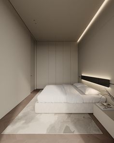 a large white bed sitting in the middle of a room