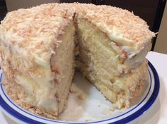 a cake that has been cut in half on a blue and white plate with one slice taken out