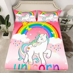 a pink bed with a unicorn on it