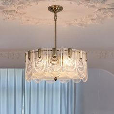 a chandelier hanging from the ceiling in a room