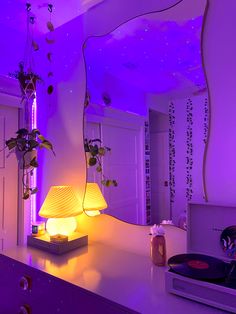 a room with purple lighting and plants on the wall, along with a record player