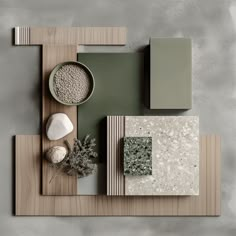 an overhead view of various materials and colors on a wooden table with grey walls in the background