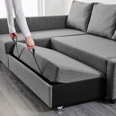 a person is pulling the pull out sofa bed