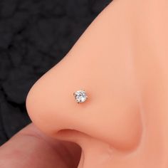 a close up of a fake nose with a single diamond in it's center