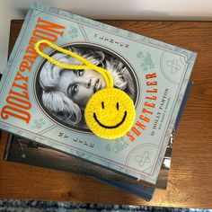 there is a book with a smiley face on it and a yellow string attached to the cover