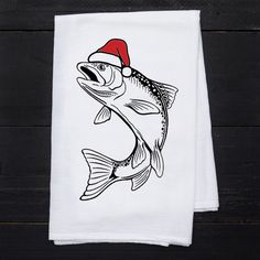 a white dish towel with a fish wearing a santa hat on it's head