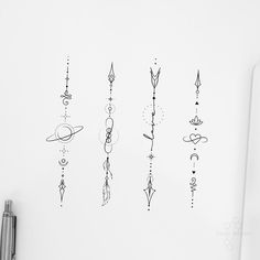 a white wall with some drawings on it and a pen next to the drawing board