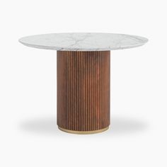 a round marble table with gold trimmings on the base and a white marble top