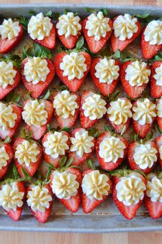 strawberries with white and yellow frosting in a baking pan