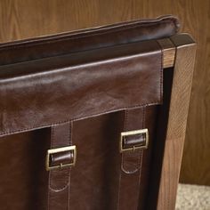 a brown leather briefcase sitting on top of a table