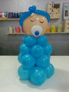 there is a balloon sculpture that looks like a girl with eyes closed and her head resting on top of the balloons