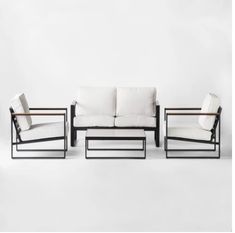 three white couches and two chairs against a white background