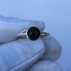 Discover the epitome of elegance with our exquisite Black Obsidian Ring. Meticulously handcrafted with passion and dedication, this distinguished piece boasts a timeless design that effortlessly complements any ensemble. Crafted with genuine gemstone, it exudes an air of luxury and opulence--a perfect everyday accessory for the modern woman. Whether you're seeking a captivating Christmas gift or a cherished anniversary token, this unique treasure promises to delight and mesmerize your loved one for years to come. Product Details - . Material: Silver . Gemstone: Black Obsidian     . Stone Size: 8mm Round  . Band color: Silver . Weight: 1.5 to 3 grams . Setting: Bezel    Processing Time : 1-3 Business Days Gift wrapping is available. Objectives - . Our Goal is 100% Customer Satisfaction. . Black Crystal Ring, Black Obsidian Ring, Obsidian Ring, Best Valentine Gift, Ring Everyday, Obsidian Stone, Everyday Ring, Unique Holiday Gifts, Everyday Rings