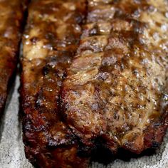 two pieces of meat sitting on top of a table