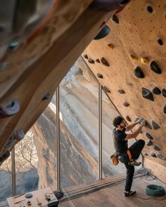 a man climbing up the side of a rock wall