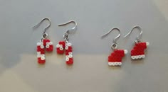 three pairs of red and white beaded earrings with santa's hat on them