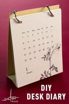 a desk calendar with the words diy desk diary written in black ink on it