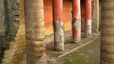 an old building that has columns in it