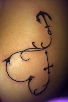 a small tattoo on the side of a woman's stomach, with an arrow