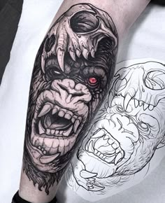 a man's arm with a tattoo on it and an image of a demon