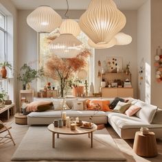 a living room filled with lots of furniture and lamps hanging from the ceiling above it